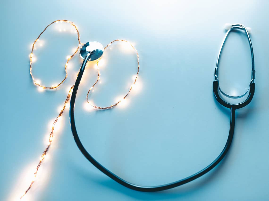 stethoscope and string lights in the shape of a kidney to represent a urology tests